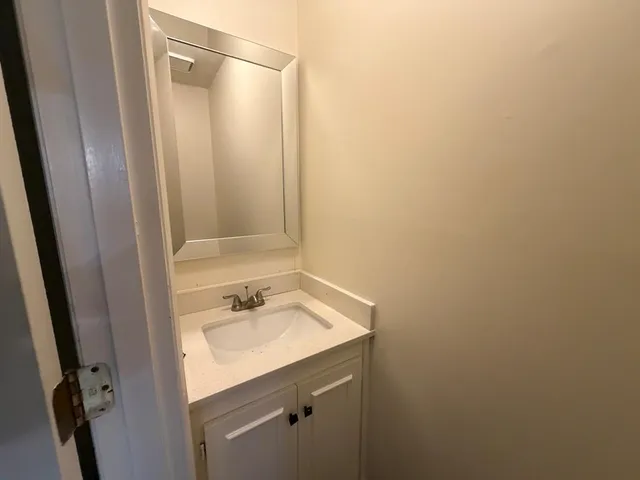 an empty room with a ceiling fan and wooden floor