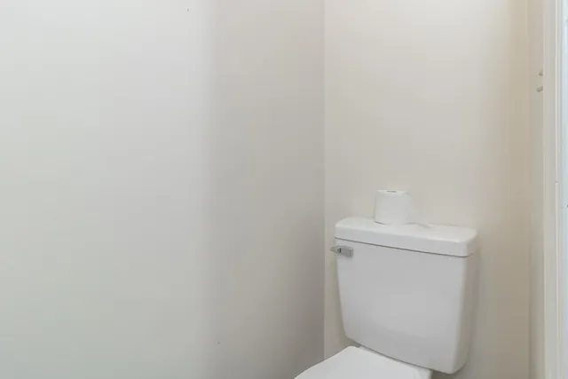 an empty room with a ceiling fan and carpet