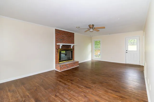 a bathroom with a granite countertop sink toilet a mirror and shower