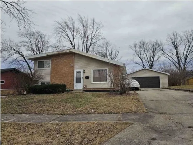a white house that has a tree in front of it