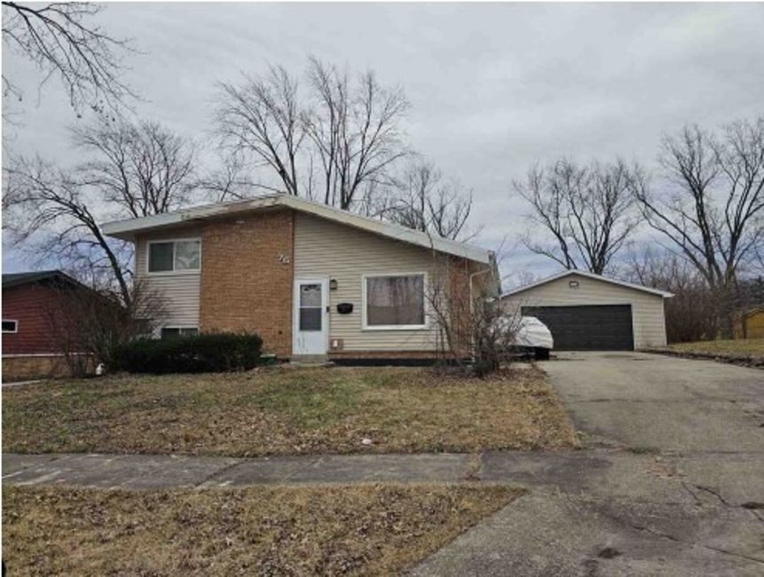 75 Water Street Park Forest, IL 60466 - Photo 2 of 2 a white house that has a tree in front of it