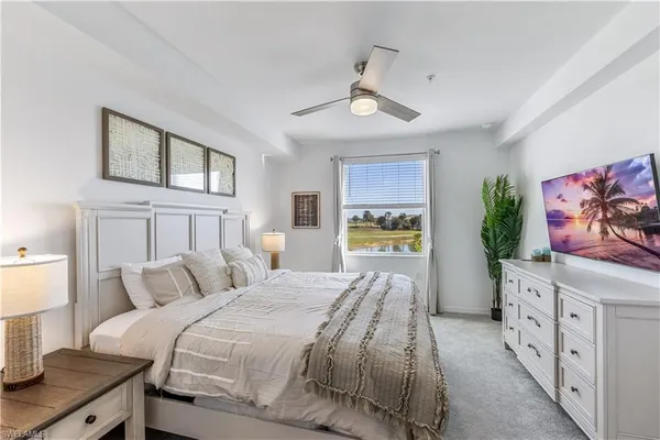 a bedroom with a bed and a painting on the wall