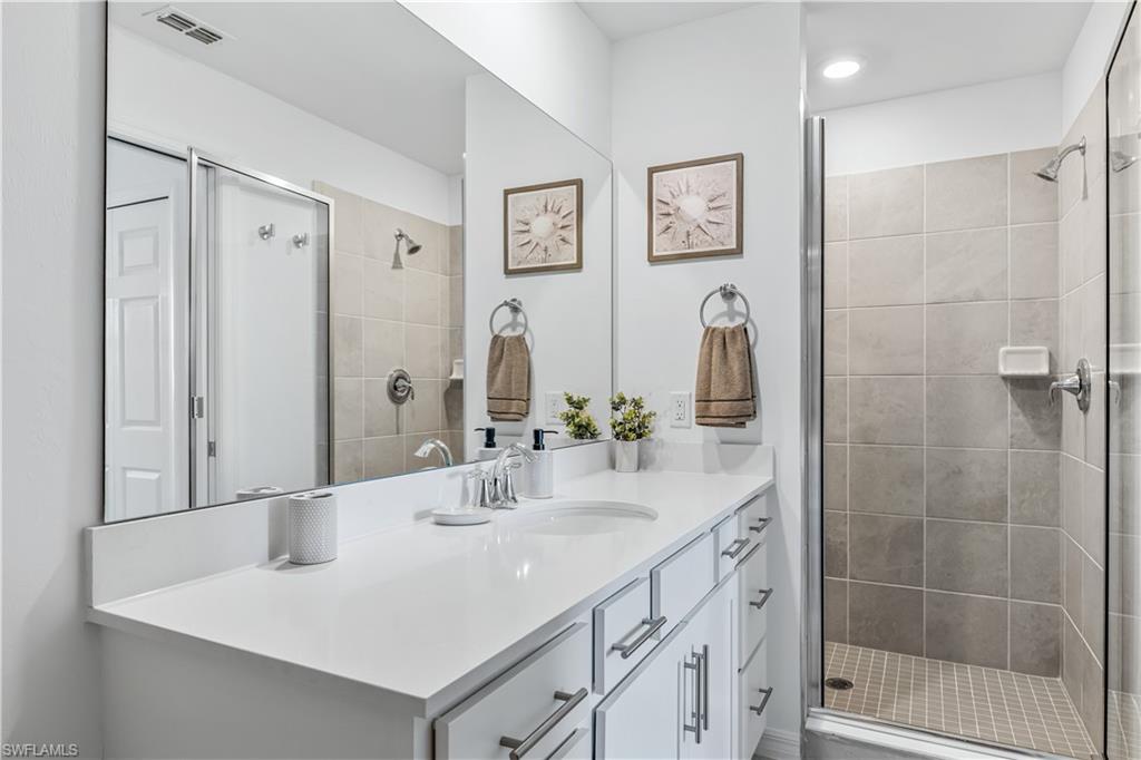 43989 Boardwalk Loop, Unit 2025 Babcock Ranch, FL 33982 - Photo 12 of 14 a bathroom with a sink and a mirror