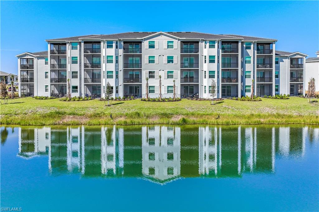 43989 Boardwalk Loop, Unit 2025 Babcock Ranch, FL 33982 - Photo 14 of 14 a front view of a building with a garden