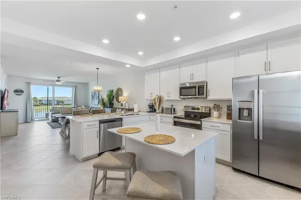 a kitchen with sink a microwave and refrigerator