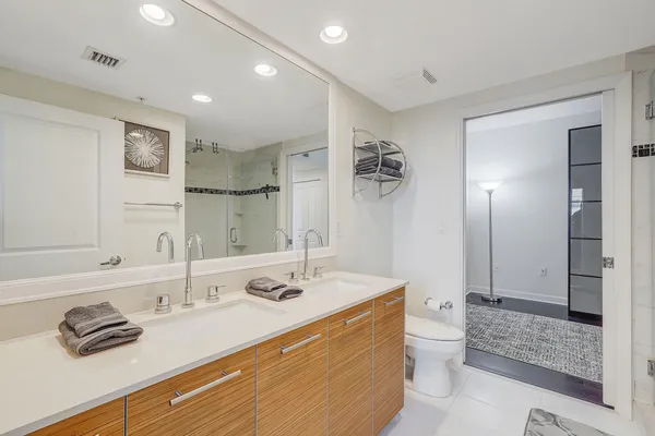 a bathroom with a sink a toilet and shower