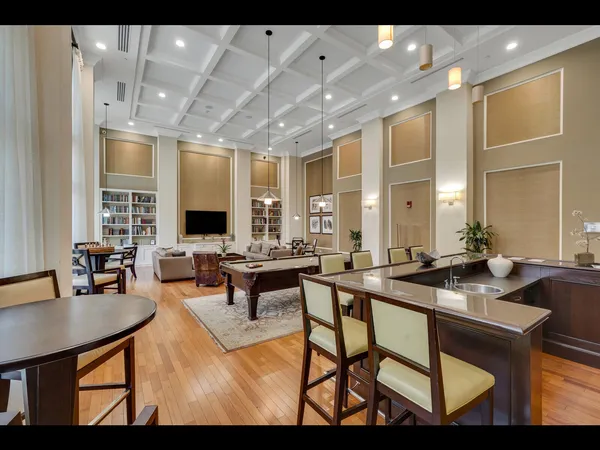 a living room with furniture a flat screen tv and a table