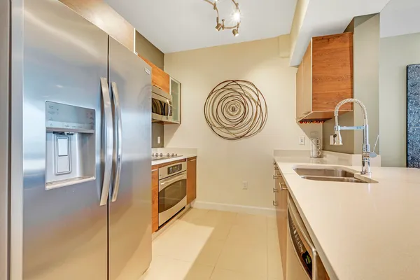a kitchen with stainless steel appliances granite countertop a sink and cabinets