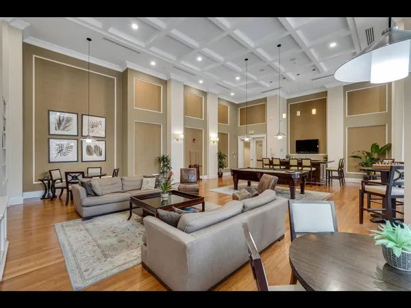 a living room with furniture wooden floor and a flat screen tv