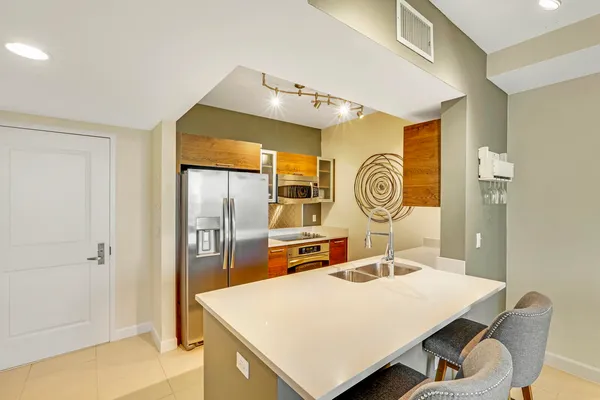 a view of kitchen island with cabinets and wooden floor