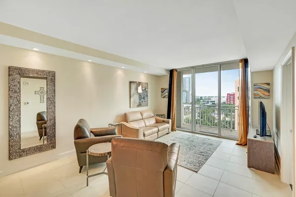 a living room with furniture and a floor to ceiling window