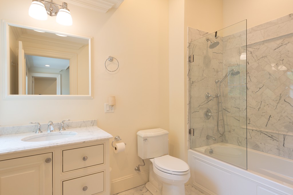 139 Arnold Road Newton, MA 02459 - Photo 13 of 30 a bathroom with a bathtub shower sink mirror and toilet