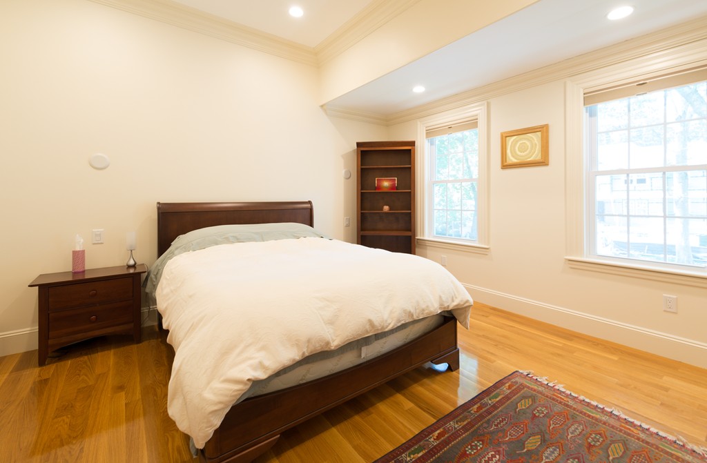 139 Arnold Road Newton, MA 02459 - Photo 16 of 30 a bed sitting in a spacious bedroom next to a window