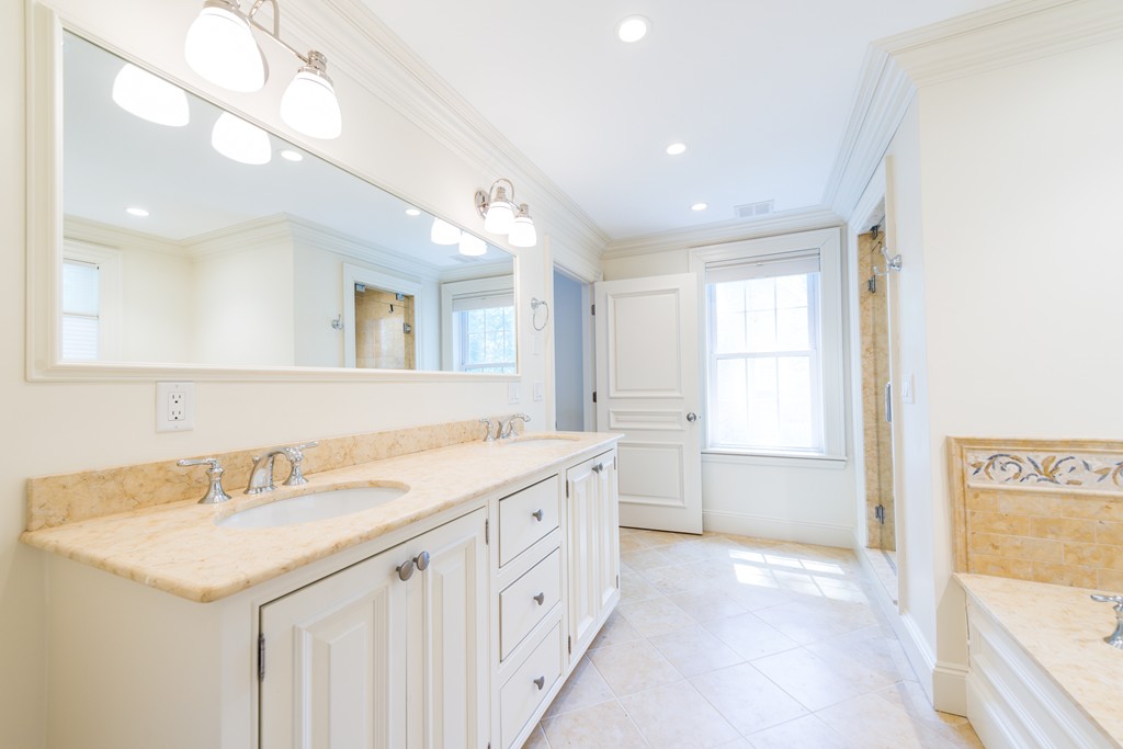 139 Arnold Road Newton, MA 02459 - Photo 19 of 30 a bathroom with a granite countertop sink and a bathtub