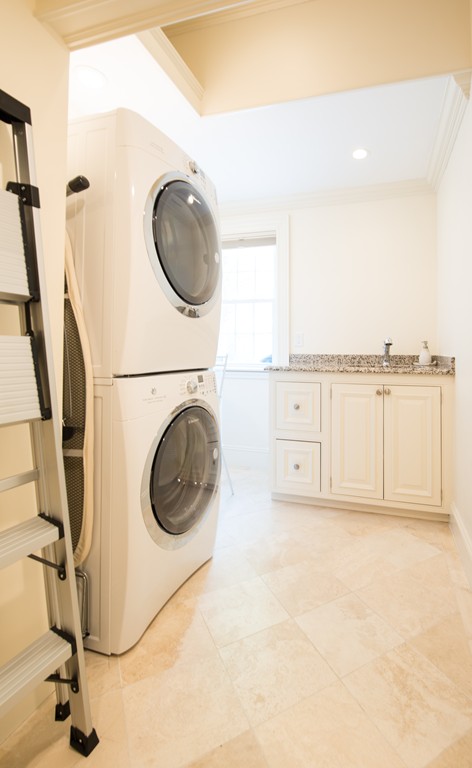 139 Arnold Road Newton, MA 02459 - Photo 20 of 30 a view of a kitchen with washing machine and a view of living room