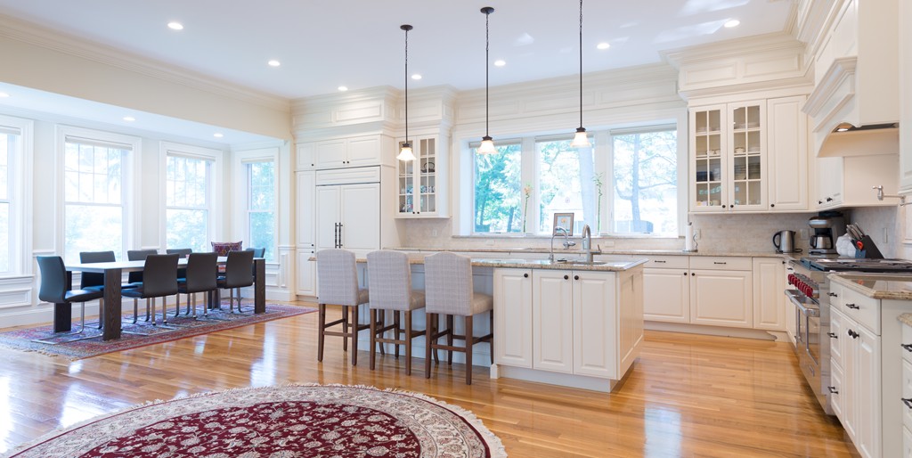 139 Arnold Road Newton, MA 02459 - Photo 3 of 30 a kitchen with stainless steel appliances granite countertop a stove a sink a dining table and chairs with wooden floor