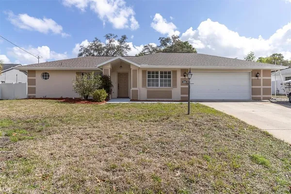 a view of a house with a yard and garage