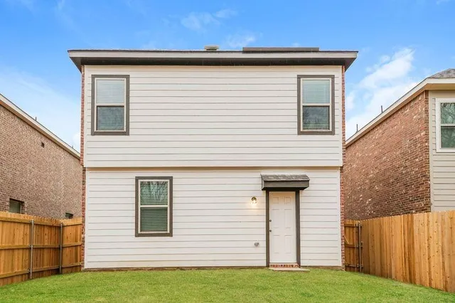 a view of a house with a yard and a garage