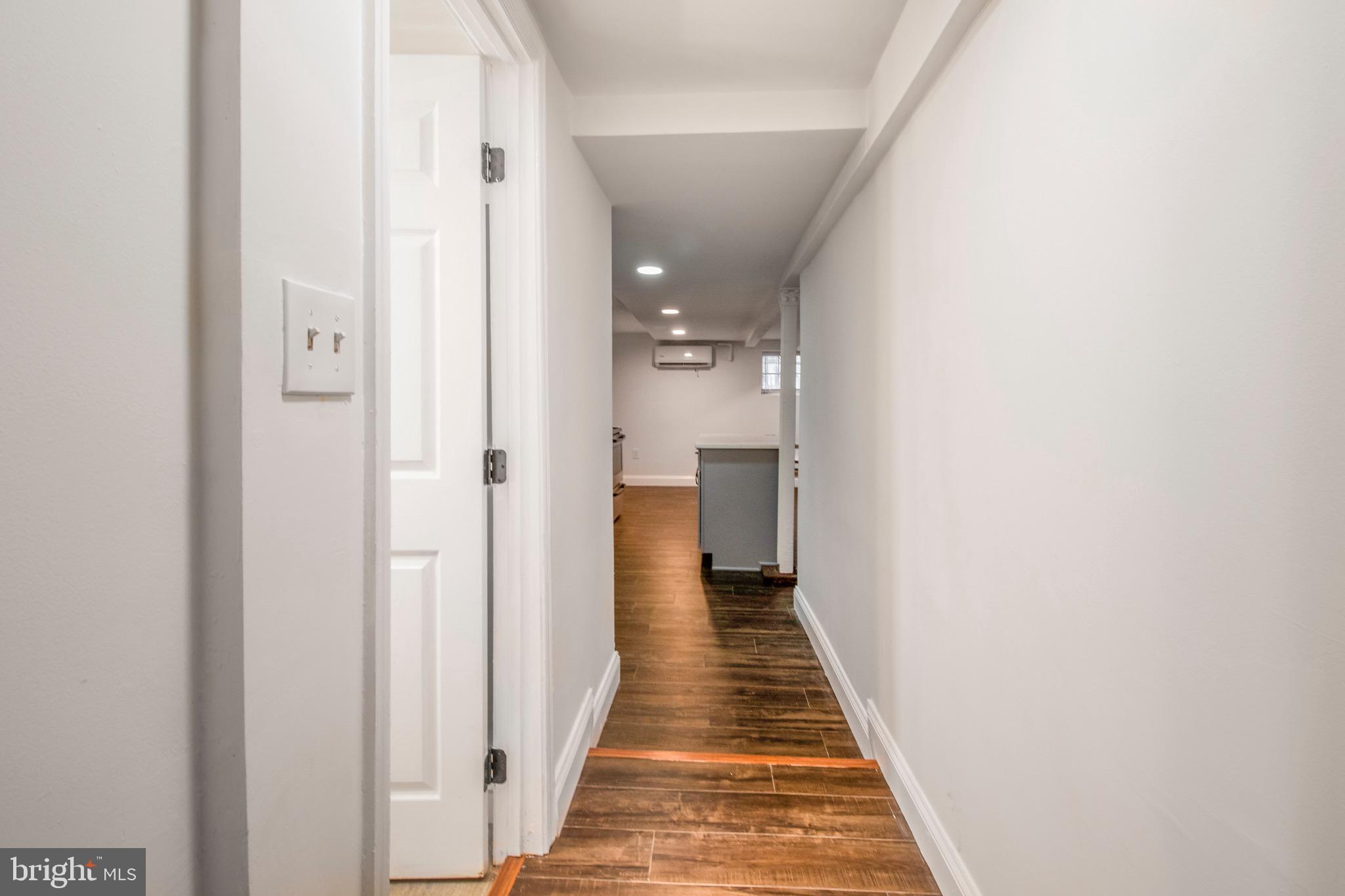 104 15th Street Southeast, Unit B Washington, DC 20003 - Photo 15 of 18 a view of a hallway with wooden floor and a bathroom