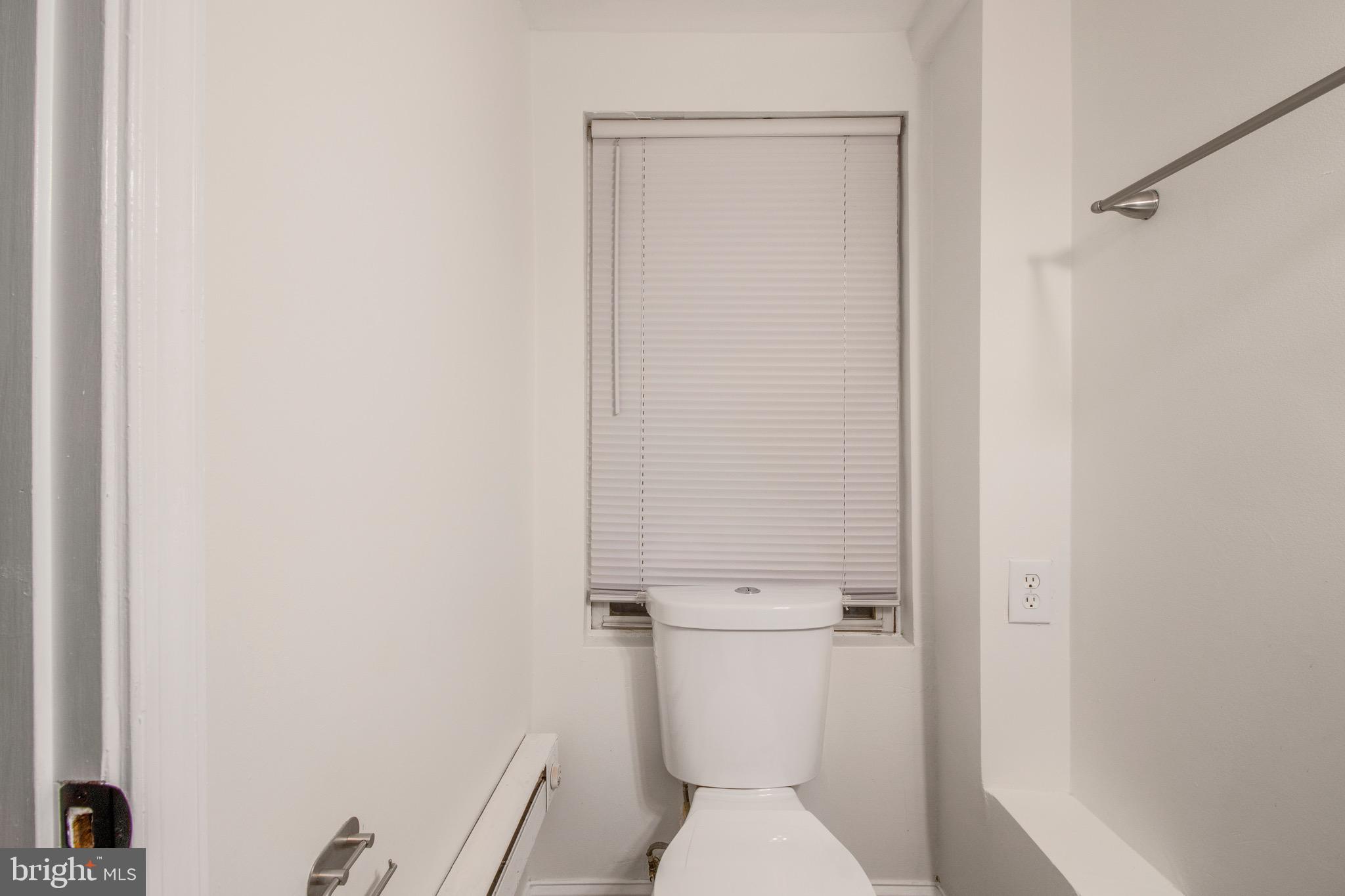 104 15th Street Southeast, Unit B Washington, DC 20003 - Photo 17 of 18 a white toilet sitting next to a shower