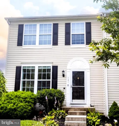 a view of a brick house with large windows