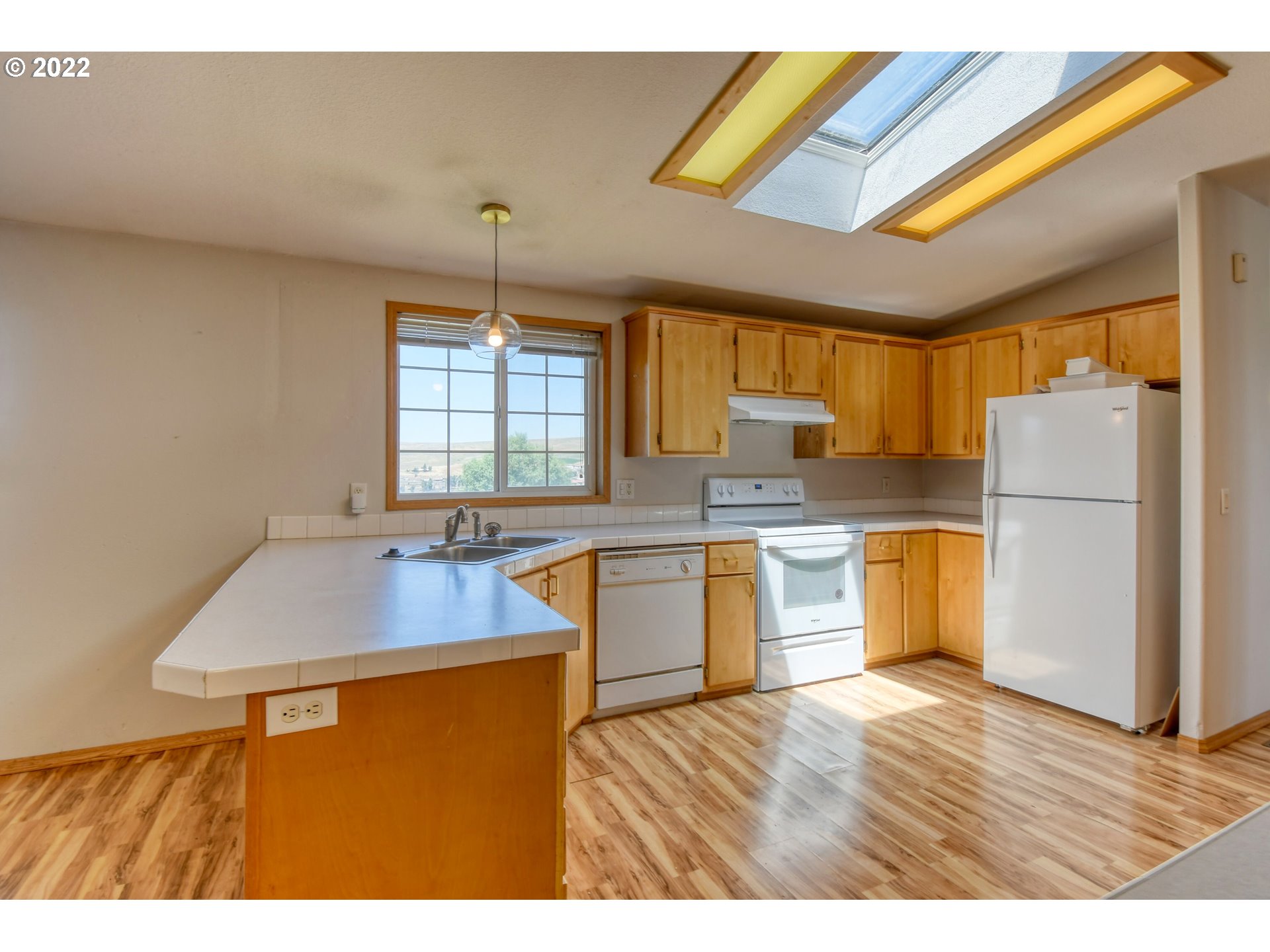 3021 Southwest River View Drive Pendleton, OR 97801 - Photo 11 of 32 a kitchen with sink refrigerator and window