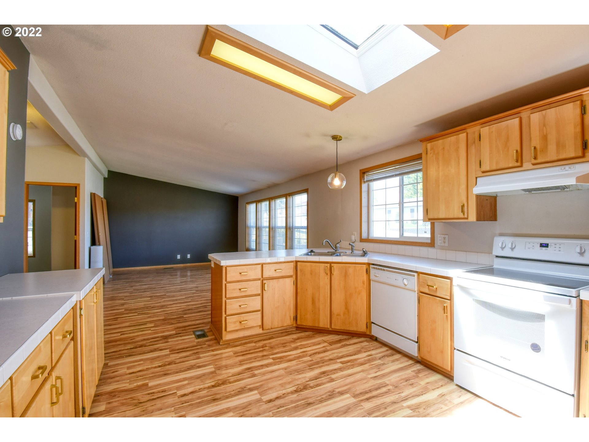 3021 Southwest River View Drive Pendleton, OR 97801 - Photo 12 of 32 a kitchen with stainless steel appliances granite countertop a stove a sink and a refrigerator