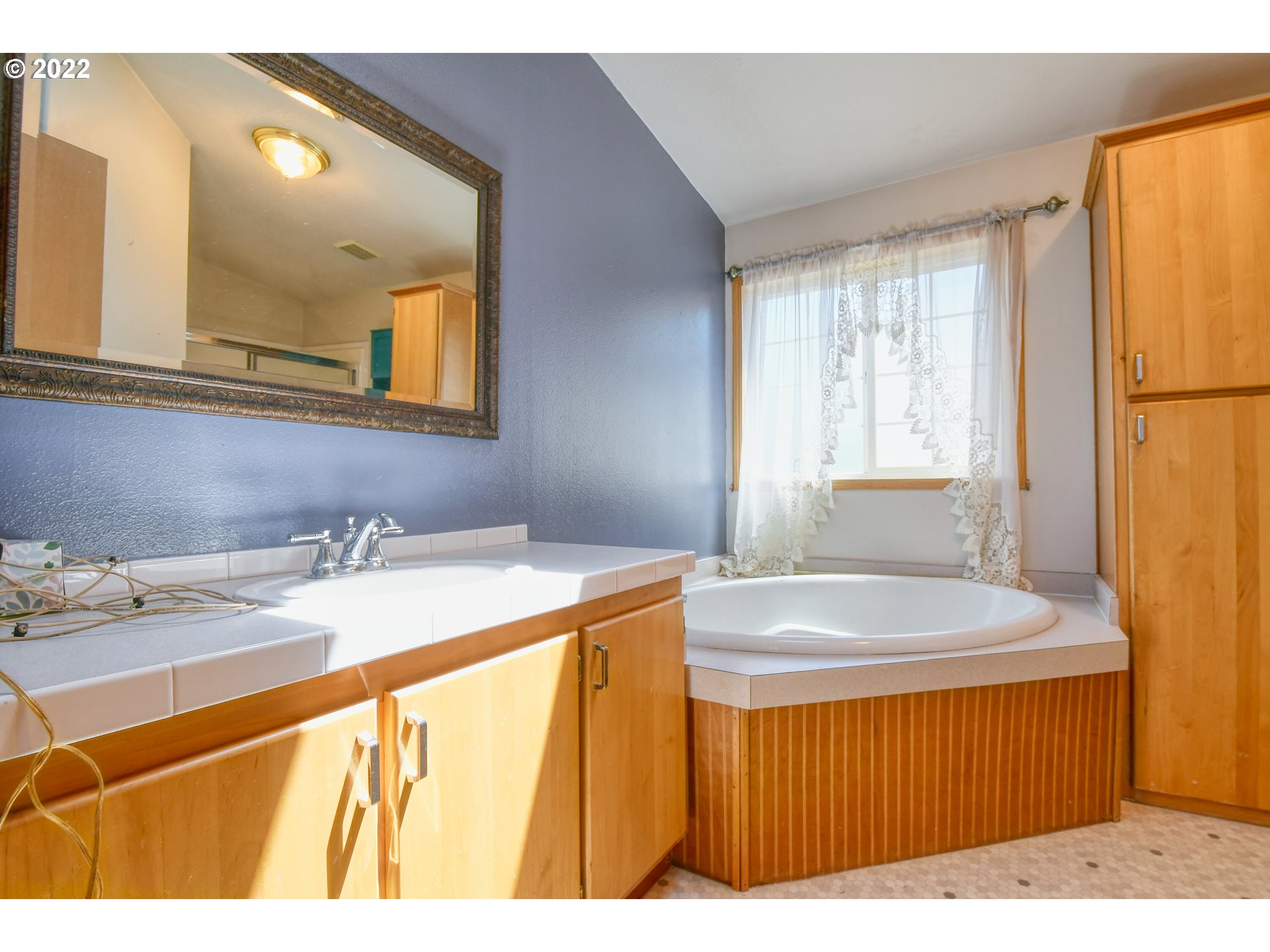 3021 Southwest River View Drive Pendleton, OR 97801 - Photo 16 of 32 a bathroom with a granite countertop sink and a mirror