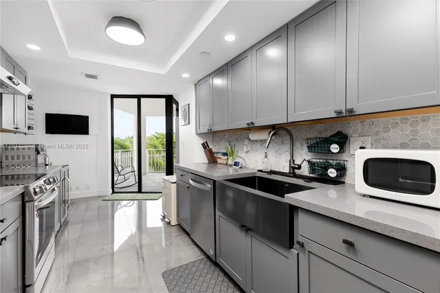 a kitchen with a sink a stove and cabinets