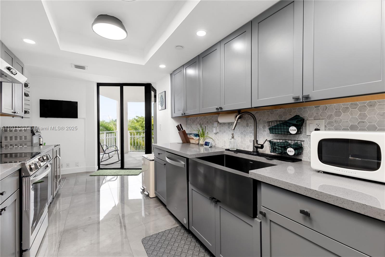 1000 Quayside Terrace, Unit 506 Miami, FL 33138 - Photo 19 of 42 a kitchen with a sink a stove and cabinets