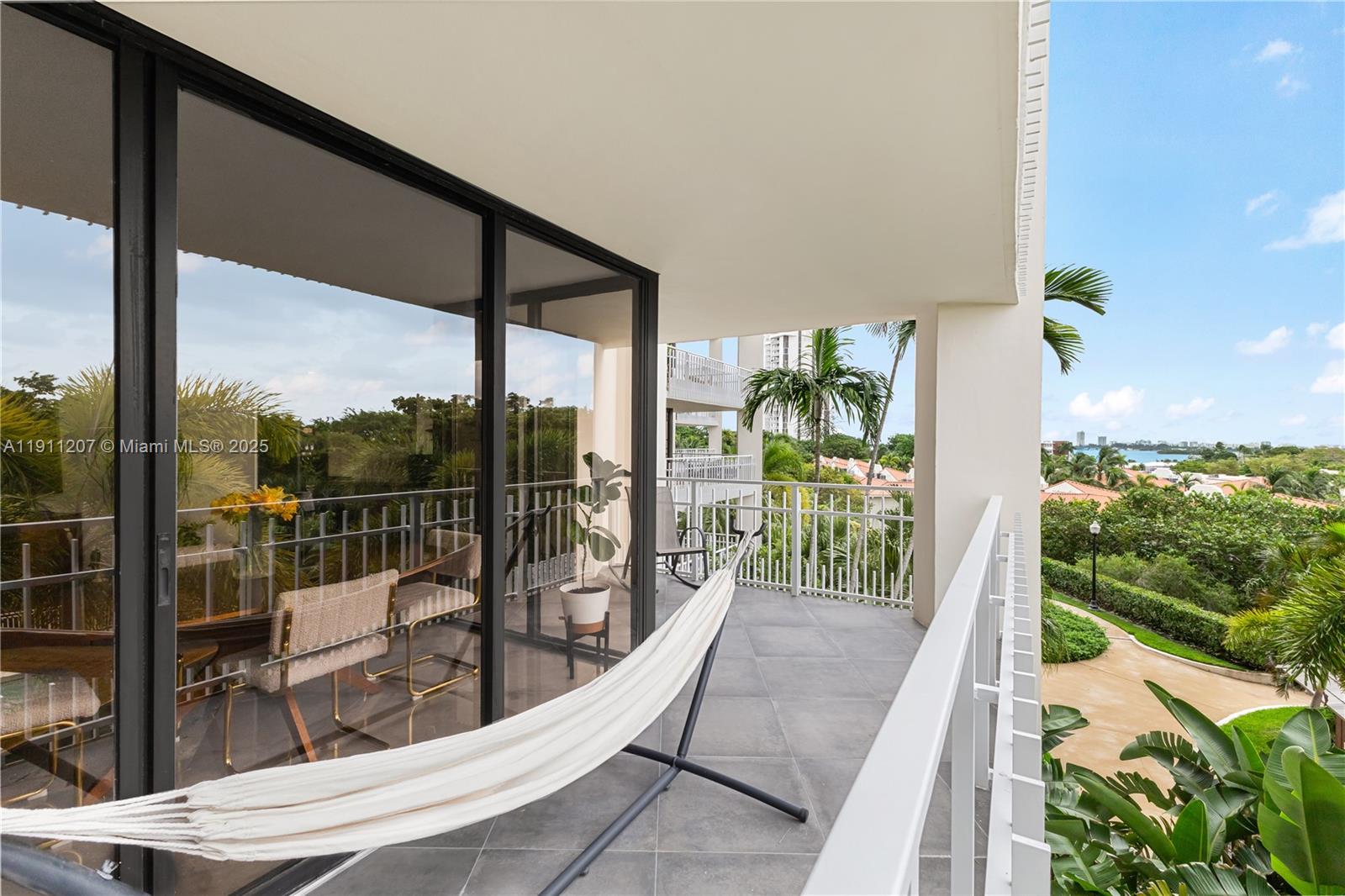 1000 Quayside Terrace, Unit 506 Miami, FL 33138 - Photo 26 of 42 a view of a balcony with floor to ceiling windows with wooden floor