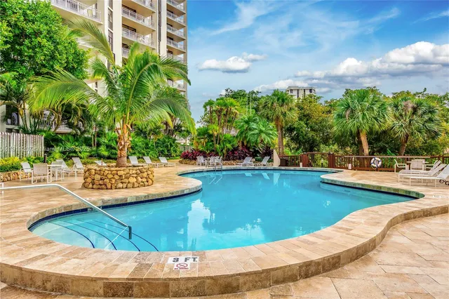 a view of a swimming pool with outdoor seating