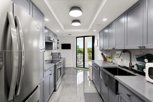 a kitchen with stainless steel appliances a sink stove and refrigerator