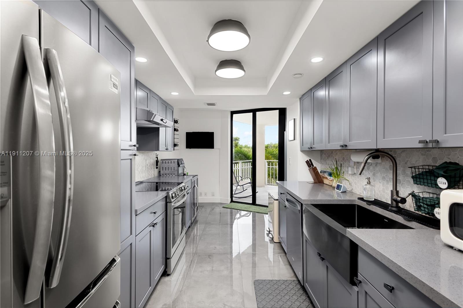 1000 Quayside Terrace, Unit 506 Miami, FL 33138 - Photo 3 of 42 a kitchen with stainless steel appliances a sink stove and refrigerator