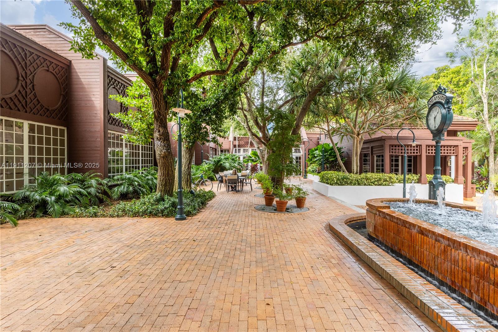 1000 Quayside Terrace, Unit 506 Miami, FL 33138 - Photo 38 of 42 a view of a house with large trees and a pathway