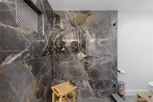 a bathroom with a toilet and shower