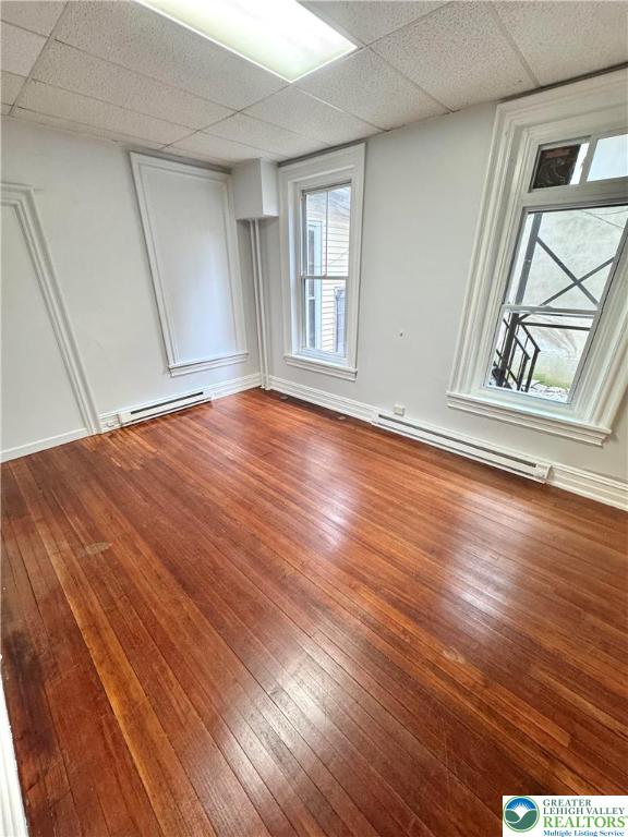 122 North 8th Street, Unit AAA Allentown, PA 18101 - Photo 5 of 9 an empty room with wooden floor and windows