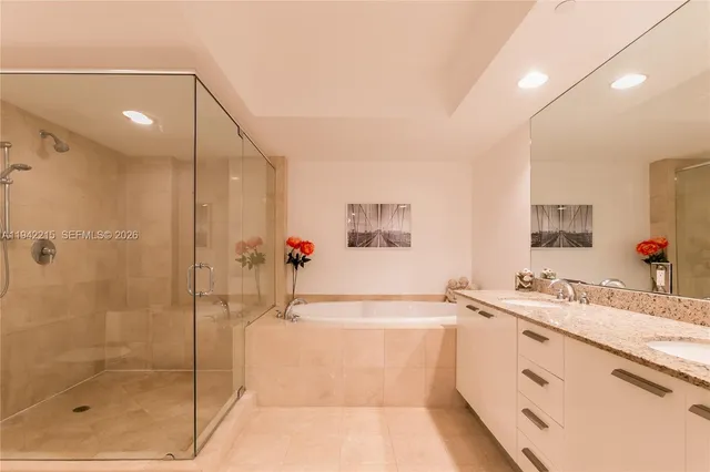 a bathroom with a tub sink and mirror
