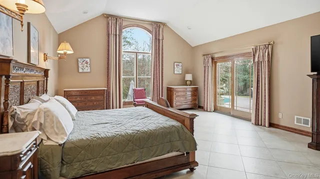 a bedroom with a bed and a large window