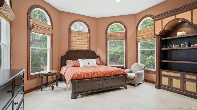 a spacious bedroom with a bed and a window
