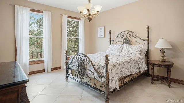 a bedroom with a bed chair and a window