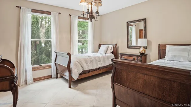 a bedroom with a bed chair and window