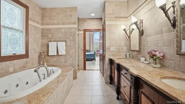 a bathroom with a granite countertop sink a bathtub and shower