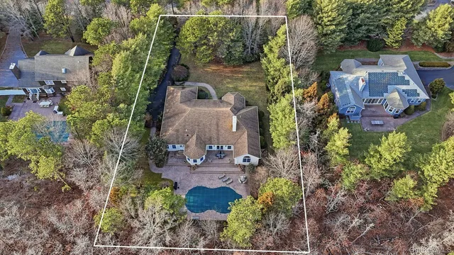 an aerial view of a house with yard swimming pool and outdoor seating