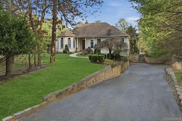 a front view of a house with yard patio and green space