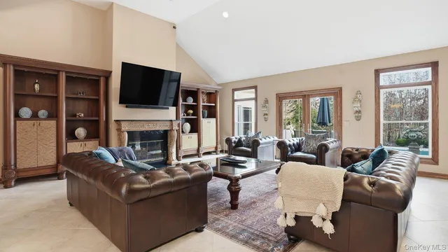 a living room with fireplace furniture and a flat screen tv