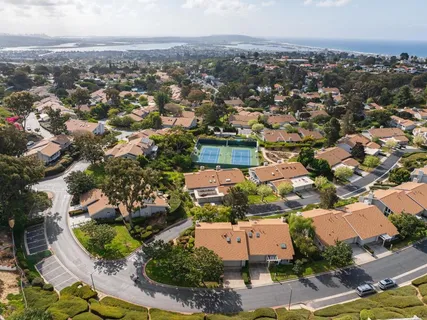an aerial view of residential houses with outdoor space