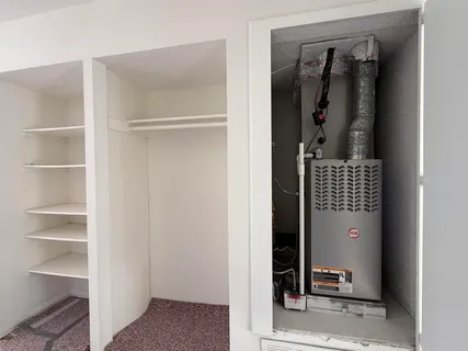 a living room with kitchen island granite countertop furniture and a large window