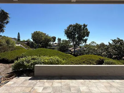 a view of a chair and tables back yard of the house