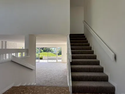 a view of an empty room with stairs
